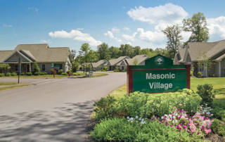 Residential street with sign in Masonic Village at Sewickley
