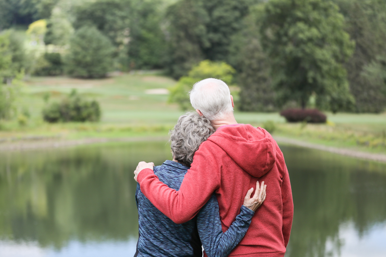 Couple gazing out at pond